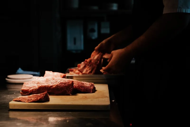 Szene in einer modernen Küche mit perfekt vorbereitetem Fleisch auf einem Schneidebrett.
