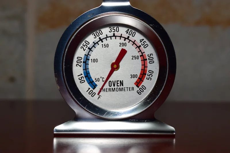 Nahaufnahme eines Gas-Räucherofen-Thermostats, der die präzise Temperaturanzeige zeigt.