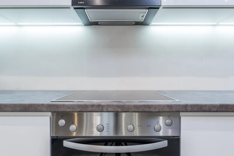 Detailaufnahme der glatten schwarzen Glasoberfläche eines Induktionskochfeldes mit intuitiver Bedienung.