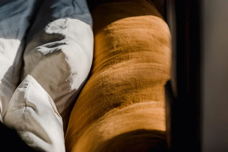Nahaufnahme der weichen, atmungsaktiven Stofftextur und Memory Foam Füllung eines Kniekissens.