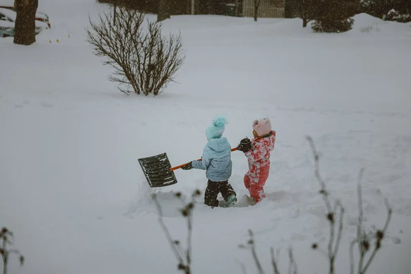 Eine farbenfrohe Kinder-Schneehose liegt isoliert auf neutralem Hintergrund, bereit für den Winterspaß.