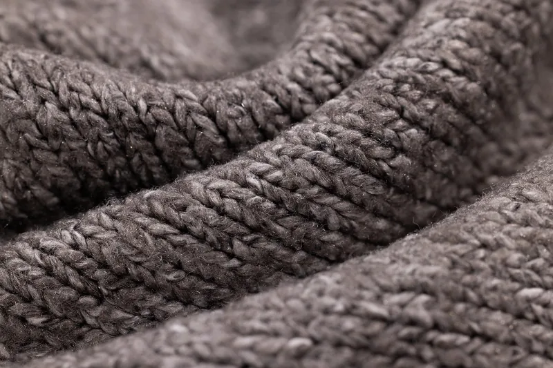 Detaillierte Textur eines Skipullovers, die die Qualität des warmen und atmungsaktiven Materials zeigt.