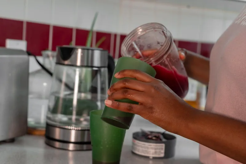 Ein frisch zubereiteter Smoothie in einem Glas auf einer modernen Küchentheke, bereit zum Genuss.