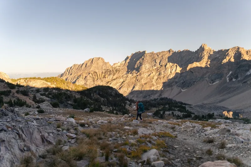 Atemberaubende alpine Berglandschaft bei Sonnenaufgang, die Freiheit und Abenteuer beim Trekking symbolisiert.