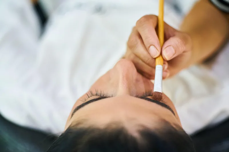 Nahaufnahme des feinen Bürsten-Applikators eines Wimpern Boosters für präzises Auftragen.